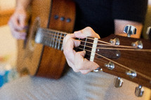 a man playing an acoustic guitar 