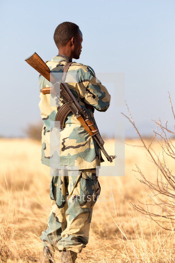 a soldier carrying a rifle 