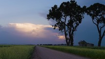 A Quiet Dirt Road and a Colorful, Stormy Evening Sky.