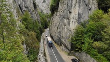 Winding road between towering limestone cliffs in Bicaz Gorge in Romania.
