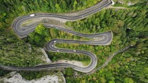 Aerial view of vehicles driving on Serpentine Highway in Cheile Bicazului in northeastern Romania.