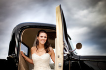 bride stepping out of an old truck