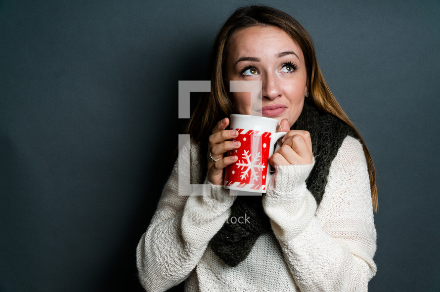Young woman holding winter mug 