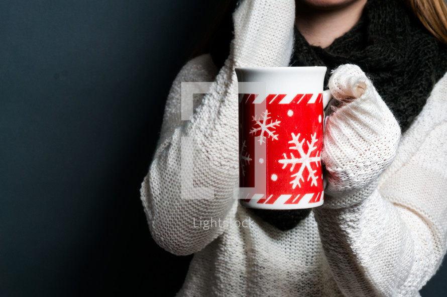 a young woman holding a winter mug 