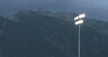 Football lights and mountain