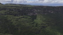 Drone flies over canyon on sunny afternoon