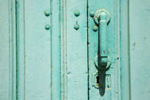 door handle on a turquoise door 