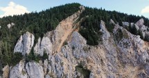 Scenic Rocky Formation Of Hasmasul Mare Mountain With Dense Pine Tree Foliage In Piatra Singuratica, Romania. aerial drone orbit