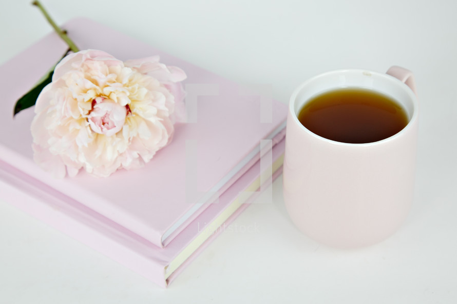 pink flower on pink notebooks and coffee 
