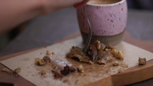 Woman eating cake with coffee in trendy cafe - close up