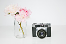 vintage camera and flowers in a vase 