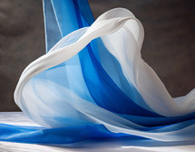 draped fabric lengths in blue and white with one floating into place