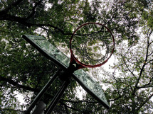 looking up at a basketball hoop on a gloomy day