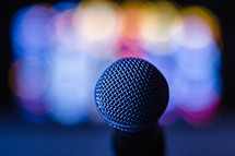 Colored lights behind a microphone.