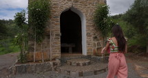 Mother walking into small church in tropical country side