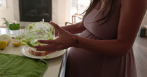 Pregnant woman makes avocado toast 