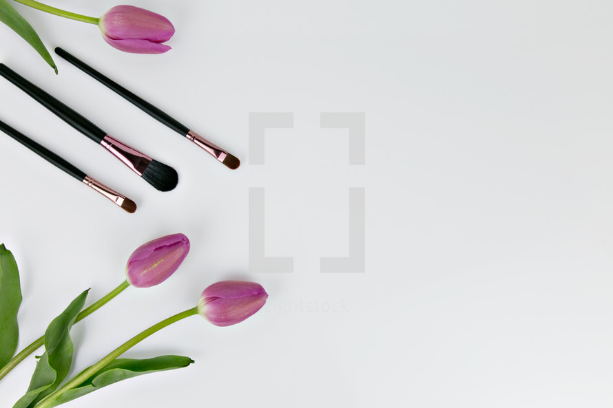 makeup brushes and pink tulips 