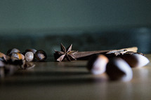 Star Anise, Hazelnuts and Cinnamon on Wooden Board.