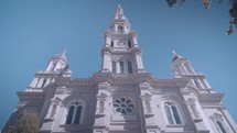 A rising view of a white marble catholic cathedral