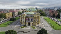 Yellow historical building of Croatian National Theatre in Zagreb, aerial pan