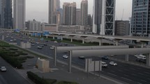 Downtown Dubai with buildings, skyscrapers and cars and traffic driving on Shiek Zayed road in the United Arab Emirates. 