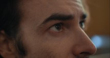 Closeup of eyes of worried, emotional man in church.