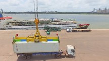 Crane loading truck with ship container in a port in Brazil 
