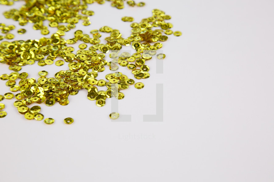 gold sequins on a white background 