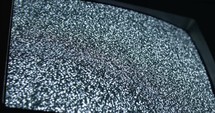 TV static noise, glitching on television screen with poor signal.
