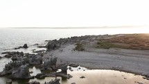 Flying over thousands of birds perched on cliffs during sunset