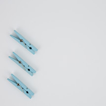 blue clothespins on a white background 