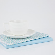 coffee cup on blue and floral planners 