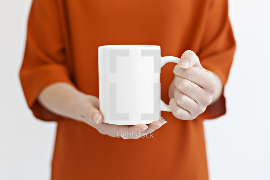 a woman holding a coffee mug 
