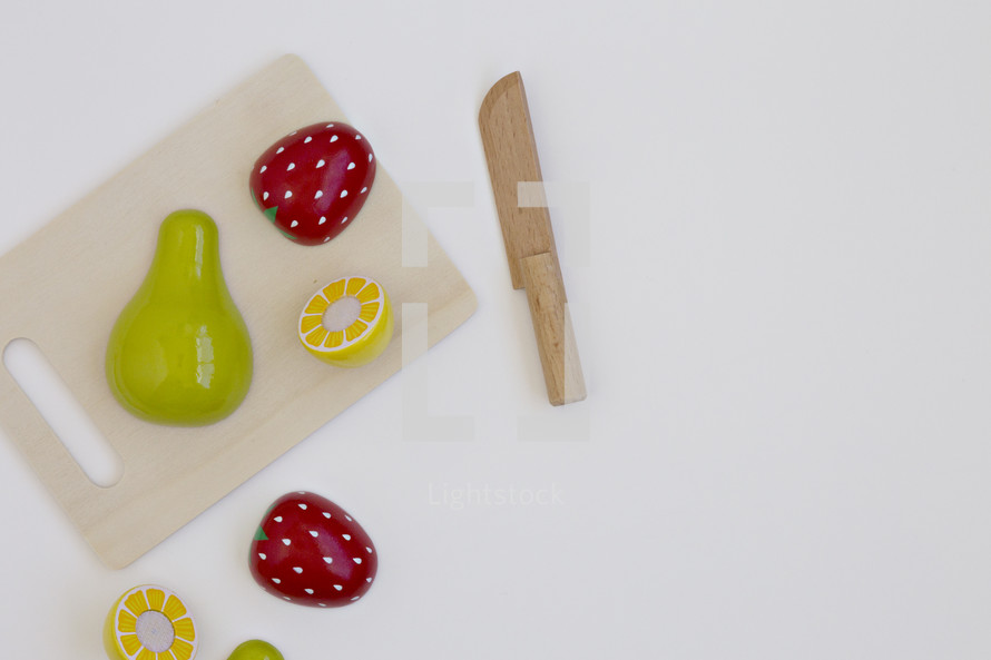 toy fruit on a toy cutting board