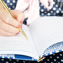 a woman writing in a sleep journal 