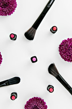 lipstick and makeup brushes and purple mums 
