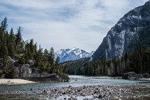 river, riverbanks, trees, forest, snow capped, mountains, outdoors, nature, water, sky, stones 