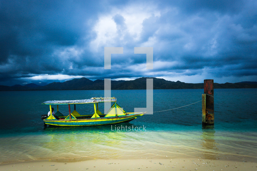 Boat tied to a post on Rat Island off northern coast Haiti.
