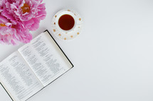 pink flowers, open Bible, and tea cup 
