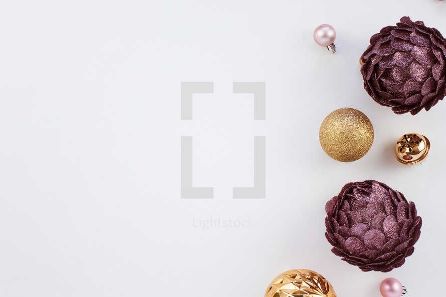 purple, pink, and gold Christmas ornaments on white 
