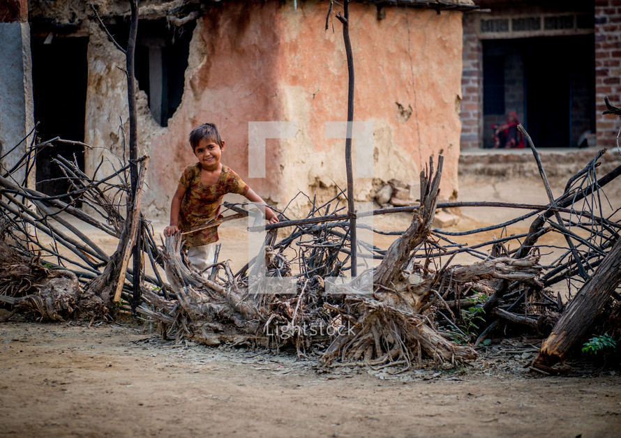 a child playing with sticks in India 