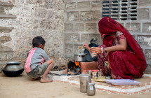 a woman cooking on the streets of India 
