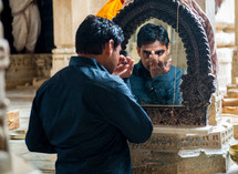 a man looking in the mirror in India 