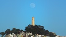 Slow Zoom Shot of Coit Tower with Full Moon Rising Above - San Francisco, California
