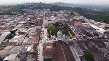 Filandia, Quindío Town Square With Rolling Green Hills In Background. Aerial Circle Dolly Shot