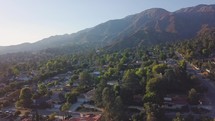 Aerial view of a beautiful neighborhood near Los Angeles with lots of green trees.
