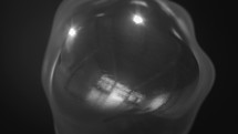 Shiny Liquid Metal Ball Spinning In Dark Space. - close up, animation