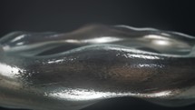 Silver Metallic Bangle With Wavy Design Rotating. abstract, macro shot