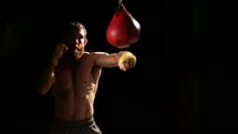 man punching a punching bag in slow motion 