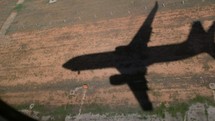 Shadow of an airplane getting larger as it lands